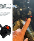 Badass Universal Motorcycle Kill Switch With Horn Button Handlebar Mounted Starter Toggle Wiring Harness Clamps For Street Cruiser And Dirt Bike Riders, with hand pressing red button.