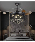 Total Game Changer 42 Inch Black Crystal Ceiling Fan With Adjustable Led Light And Wireless Remote above a modern bed.