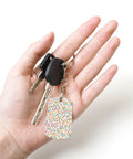 Slick Mini Abstract Rectangle Aluminum Keychain Featuring A Dope Scattered Grid Plated Finish Rust Resistant Metal Key Holder And Bag Charm Daily Accessory For Her And Him held in hand.