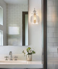 Kira Home Rayne 10" Modern Farmhouse Wall Sconce for Bathroom Vanity, Pack of 2, featuring a clear jar glass shade and brushed nickel finish.