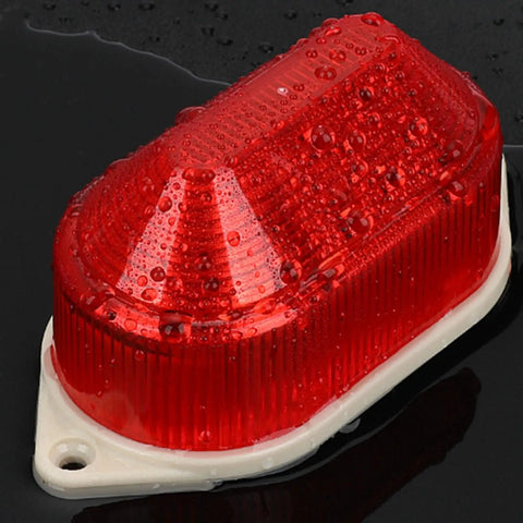 Red LED Strobe Warning Light For Emergency Safety Use with weatherproof lens and durable construction, wet surface view.