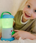 Child holding a Durable Light And Sound Camping Lantern Toy With Six Color Modes And Cool Sound Effects For Kids in green color mode