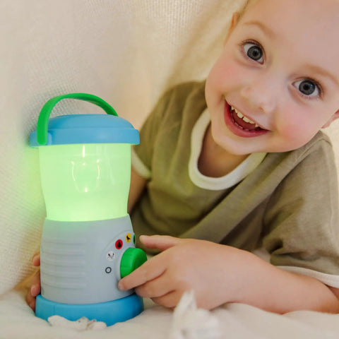 Child holding a Durable Light And Sound Camping Lantern Toy With Six Color Modes And Cool Sound Effects For Kids in green color mode
