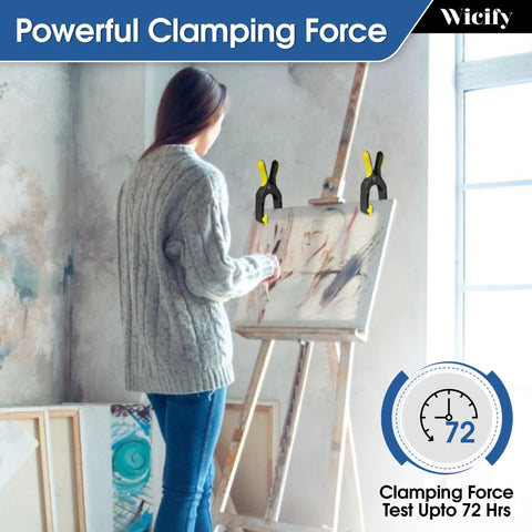 Wicify 6-inch heavy-duty plastic spring clamps (pack of 4) with yellow handles clamping a painting on an easel