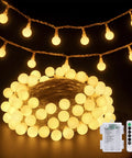 Warm White 100 LED Globe Battery Operated Christmas Lights Indoor With Eight Modes glowing softly with remote and battery pack visible