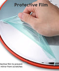 Hand removing protective film from 12 Inch Convex Safety Traffic Mirror Boasts Crisp Fisheye Vision for clear view.