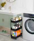 Three Tier Rolling Storage Cart With Adjustable Shelves, Mobile Utility Organizer On Wheels For Kitchen, Bath, And Laundry, Narrow Space Saver In Black Finish next to a washer and sink setup.