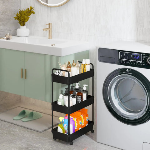 Three Tier Rolling Storage Cart With Adjustable Shelves, Mobile Utility Organizer On Wheels For Kitchen, Bath, And Laundry, Narrow Space Saver In Black Finish next to a washer and sink setup.