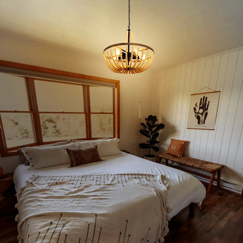 Bedroom with Boho Wood Bead Chandelier With Five Lights And 20 Inch Diameter, rustic farmhouse ceiling pendant, over bed.