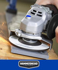 6 Amp 4-1/2 Inch Angle Grinder with 3 grinding wheels, tool-free guard adjustment, and onboard wrench storage in use