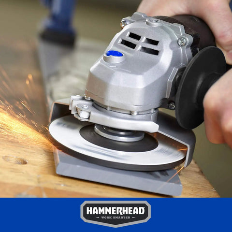 6 Amp 4-1/2 Inch Angle Grinder with 3 grinding wheels, tool-free guard adjustment, and onboard wrench storage in use