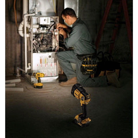 Cordless 20V Max LED Work Light With 4 Bright LEDs 1500 Lumens illuminating a dark jobsite with worker in background