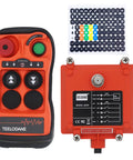 Front view of orange Q200 wireless crane remote control transmitter with green Start button and red dial; includes receiver and sticker sheet.