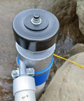 Top view of Beefy 1000W 220V AC Hydro Turbine Generator For Off Grid Power 3500 RPM Small Hydroelectric Generator installed by rocks.