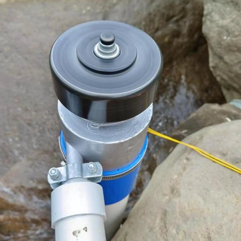 Top view of Beefy 1000W 220V AC Hydro Turbine Generator For Off Grid Power 3500 RPM Small Hydroelectric Generator installed by rocks.