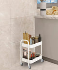Durable 2 Tier Metal Rolling Cart With Handle And Locking Wheels White in a kitchen with jars and bottles organized on it
