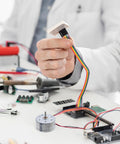 Tiny 5V DC Motor 6000 RPM With Wire Pack Of 3 For DIY Toys And Experiments, ideal for STEM projects on a budget, shown on workspace.