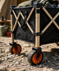 Heavy Duty Outdoor Folding Utility Wagon With 125 Liter Capacity And 600D Oxford Zero Hassle Folding Design Rolls Like A Dream On 5 Inch Silent Swivel Wheels shown on gravel surface