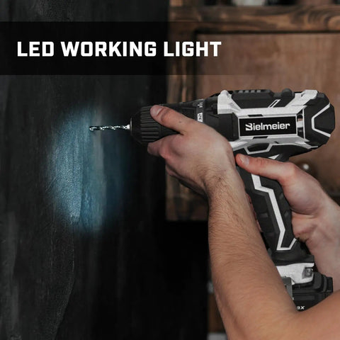 Beast Of A 20V Max Cordless Drill Set with LED light drilling into a wall, showing compact design and keyless chuck features.