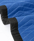 Close-up of Ultra Large 80 By 72 Inch Moving Blankets 12 Pack Beefy Heavy Duty Furniture Pads showing blue and black quilted fabric.