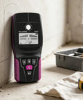 OSPSHPG Multifunctional Wall Scanner against wall, showing display features for stud, metal, and wire detection.
