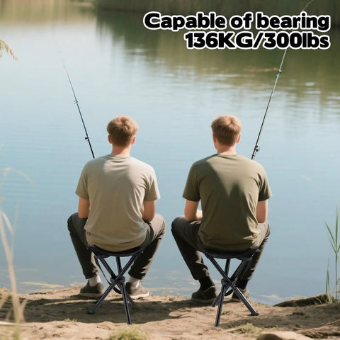 Two people fishing sitting on Lightweight Travel Folding Tripod Camping Stool Portable Chair 14.6 Inch Seat Holds Up To 210 Lbs by a lake.