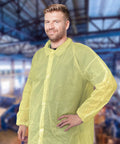 Man wearing Yellow Disposable Lab Coats For Adults XL, 50 Pack, Knee Length, No Pockets, Elastic Wrists, Hook And Loop Closure