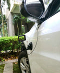 Stainless Steel Camera Safety Tether Built Tough With Colorful Coating Lanyard And Carabiner Clip securing camera to car mirror.