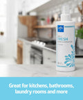 Odor Eliminator Spray 8 Oz Lightly Scented Pump Bottle on kitchen counter with blurred background, label facing camera