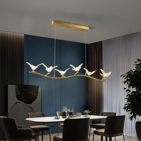 Badass Brass Bird Pendant Light Slick Modern Ceiling Fixture With Ultra Smooth Lighting And Zero Glare For Restaurants Bedrooms Offices And Hotel Hallways Game Changing Room Decor above dining table in modern setting.