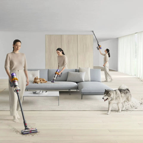 Woman using V15 Detect Total Clean Extra Refurbished Premium Vacuum Cleaner With Laser Dust Detection on wooden floor next to a dog