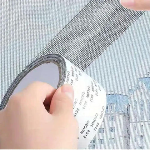 Hands applying Heavy Duty Mosquito Mesh Repair Tape 2M Patch for Dorm Screens and Curtains on window screen