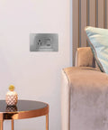 15 Amp Us Standard Wall Outlet With Dual Usb Charging Ports, Built Tough Pp Housing With Genuinely Solid Bronze Contacts, No-Hassle Hookup For Desk Lamps And Bedside Tables, Secure Screw Mount Receptacle installed beside a cozy chair.