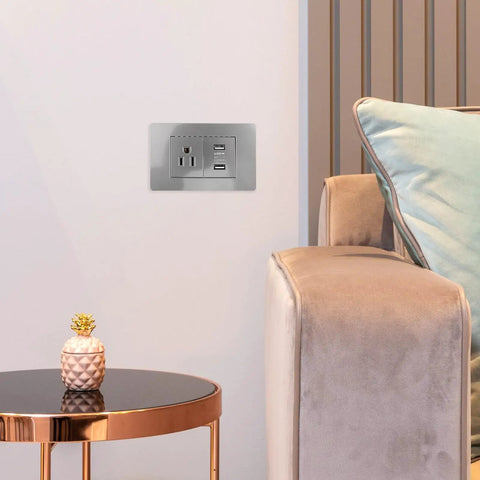 15 Amp Us Standard Wall Outlet With Dual Usb Charging Ports, Built Tough Pp Housing With Genuinely Solid Bronze Contacts, No-Hassle Hookup For Desk Lamps And Bedside Tables, Secure Screw Mount Receptacle installed beside a cozy chair.
