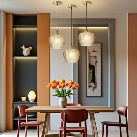 Top Shelf Amber Glass Pendant Light With Vintage Gold Trim For Kitchen Island And Dining Area Height Adjustable Cord Fits Dimmable E26 Bulbs above a dining table with flowers.