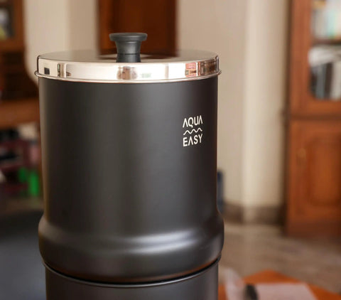 2.25 Gallon Gravity Water Filter System With Dual Activated Carbon Filters, matte finish, stainless steel tap on wooden countertop position.
