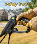 Gloved hand on safety switch of Powerful 13.5 Amp Electric Tiller Cultivator With 18 Inch Wide Tilling featuring ergonomic handle.