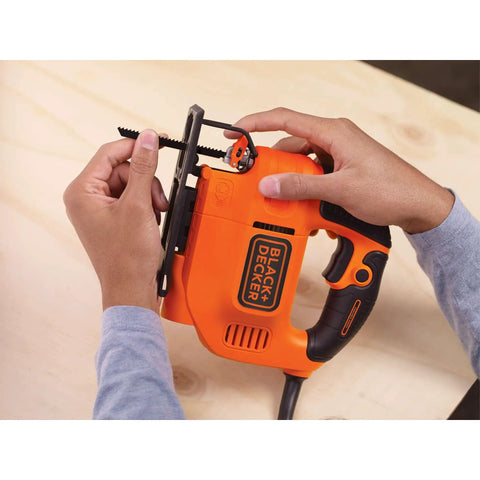 Versatile 4.5 Amp Corded Electric Jigsaw Delivering Killer Wood And Metal Cuts With Variable Speed Up To 3000 Spm, held by hands with blade attached.