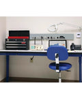 8-Outlet Surge Protector Power Strip With 6-Foot Cord, Metal Housing, mounted on a lab workbench alongside tools and equipment.