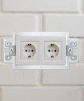 Installed view of 20 Pack Electrical Outlet Box Extenders With 40 Screws, One Gang Box Extender Kit for Receptacles and Switches on wall.