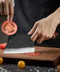 Person slicing tomato with Serbian Chef Cleaver Knife With Leather Sheath 5.8 Inch Hammered 3CR13 Blade Razor Sharp Edge Hand Sharpened