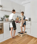 Woman and child in kitchen using sturdy wooden step stool for adults and seniors with non slip rubber tread, 5.5 inch rise