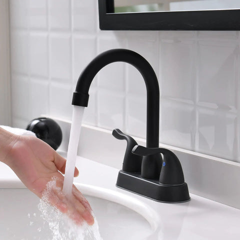 Person washing hands under Matte Black Two Handle Bathroom Sink Faucet With Pop Up Drain And Supply Lines 4 Inch Centerset Design For 2 Or 3 Hole Lavatory Vanity Sleek Modern Fixture With No Fuss Install And Precise Temperature Control.
