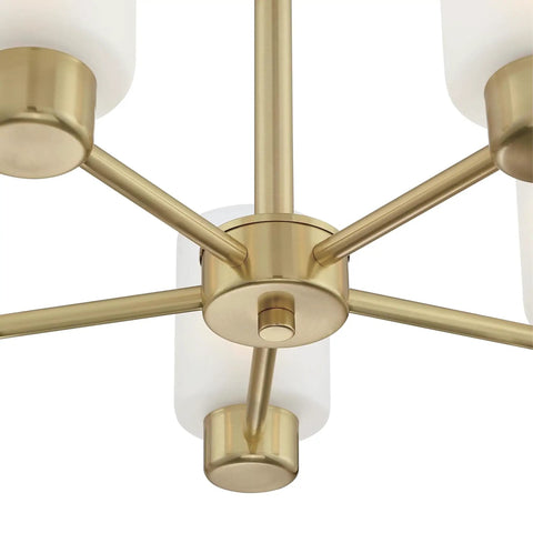Close-up of Five Light Indoor Chandelier in champagne brass finish with frosted glass, focusing on central hub design.