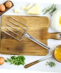 Stainless Steel Bean Sprout Fork Garden Trowel Small Digging Spade on wooden cutting board with eggs and herbs