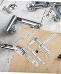 Hidden Door Hinges With Automatic Rebound For Concealed Bookcase Doors Stainless Steel Heavy Duty Pivot Hinges laid out on wood.