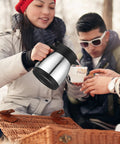 Set Of Two Heavy Duty Thermal Coffee Carafe And Creamer Pitcher In Sleek Silver Finish with double wall insulation being poured.