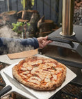 Gas Burner Attachment For Karu 2 Pro Pizza Oven - 28mbar Propane, Includes Regulator And Hose, outdoor pizza cooking scene.