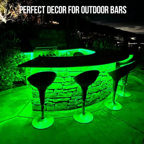 Outdoor 100Ft IP68 Waterproof LED Strip Lights illuminating a stone bar setup with green lighting at night