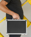 Heavy Duty Aluminum Tool Case With Handle For Home And Pros large capacity portable toolbox held by a person in front of ladder